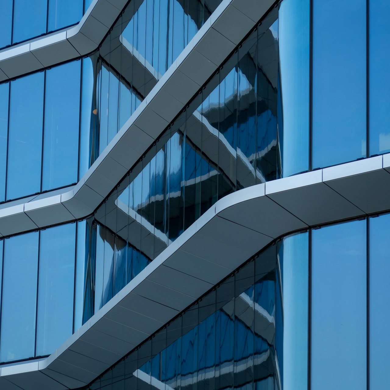 Reflections on a contemporary blue glass facade